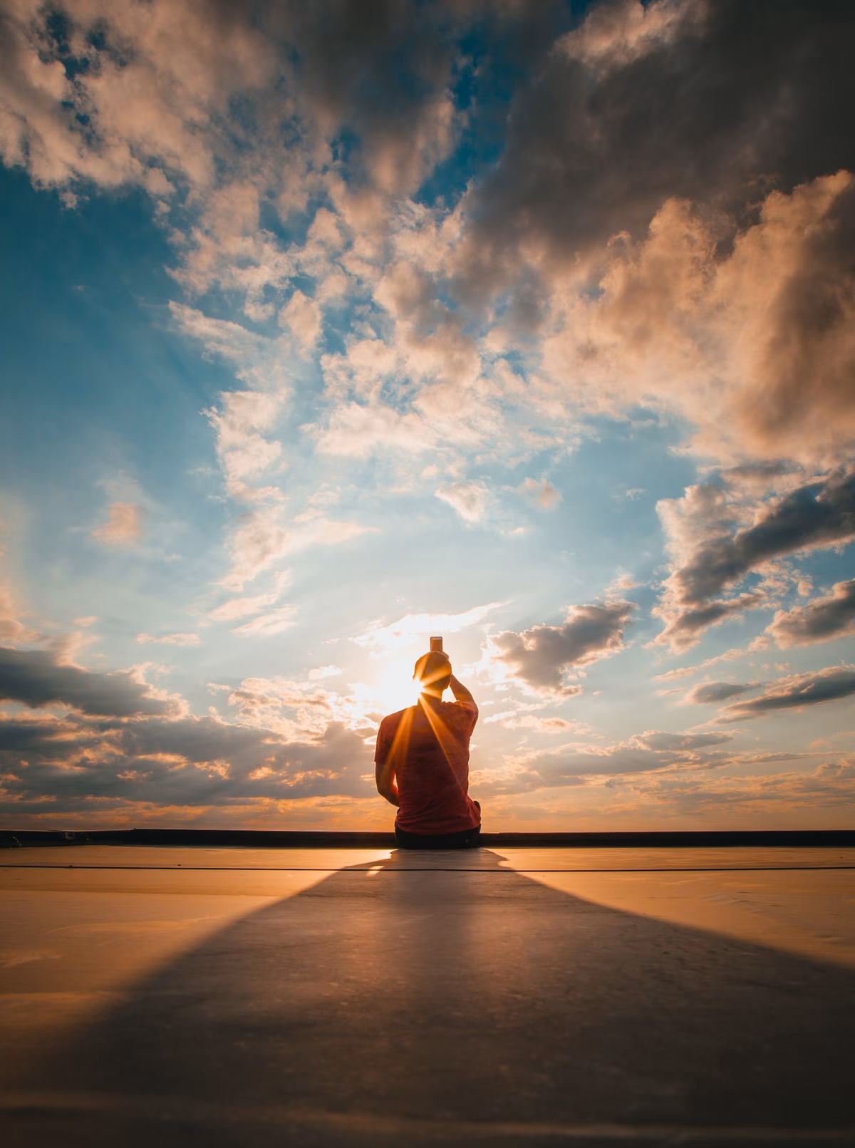 A person at golden hour, looking out to the horizon
